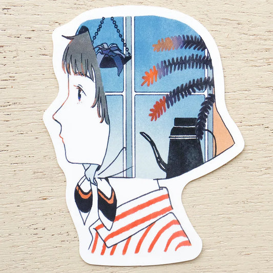 A die-cut sticker featuring an illustrated side profile of a girl with short hair, wearing a white and orange striped shirt, set against a window scene with hanging plants and a kettle. The sticker is placed on a light wood surface.