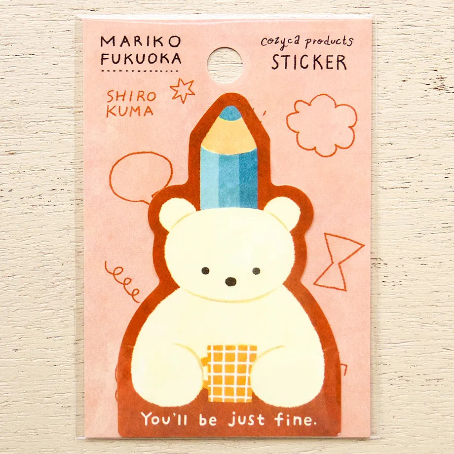 A packaged sticker featuring a cute bear-shaped character wearing a blue pencil as a hat, with the text 'MARIKO FUKUOKA' and 'SHIRO KUMA' on a pink backing card.