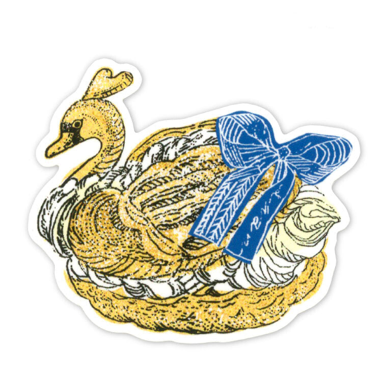 A die-cut sticker featuring an illustrated dessert swan with a large blue bow, shown on a plain white background.