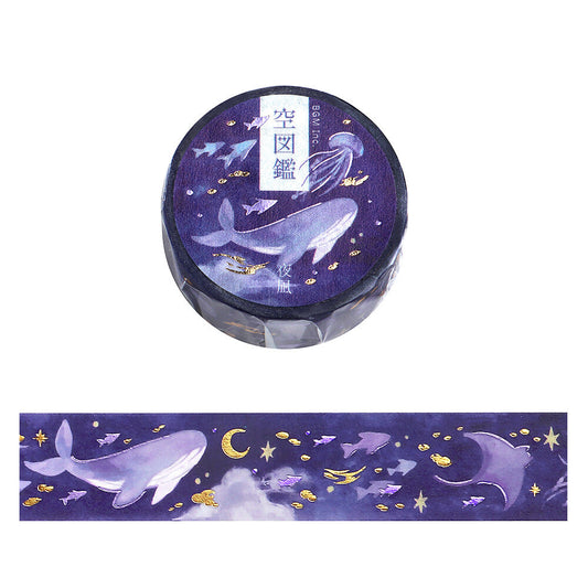 Decorative washi tape with whale and star design on a purple background
