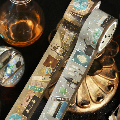 Two rolls of decorative tape with intricate designs on a dark surface.