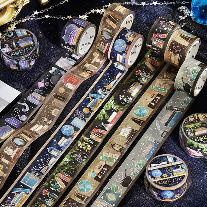 Decorative washi tape rolls with intricate magical fantasy bookcases designs on a dark background