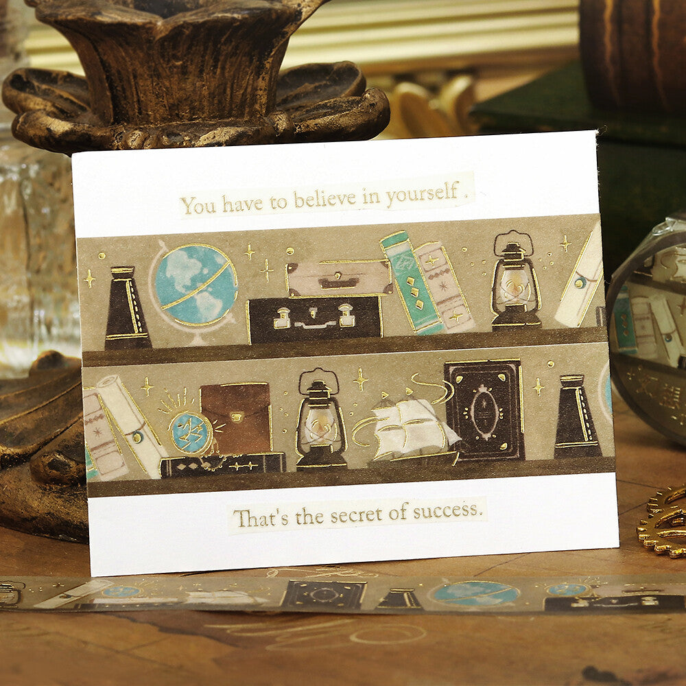 Stationery with bookshelf themed washi tape on a wooden surface.