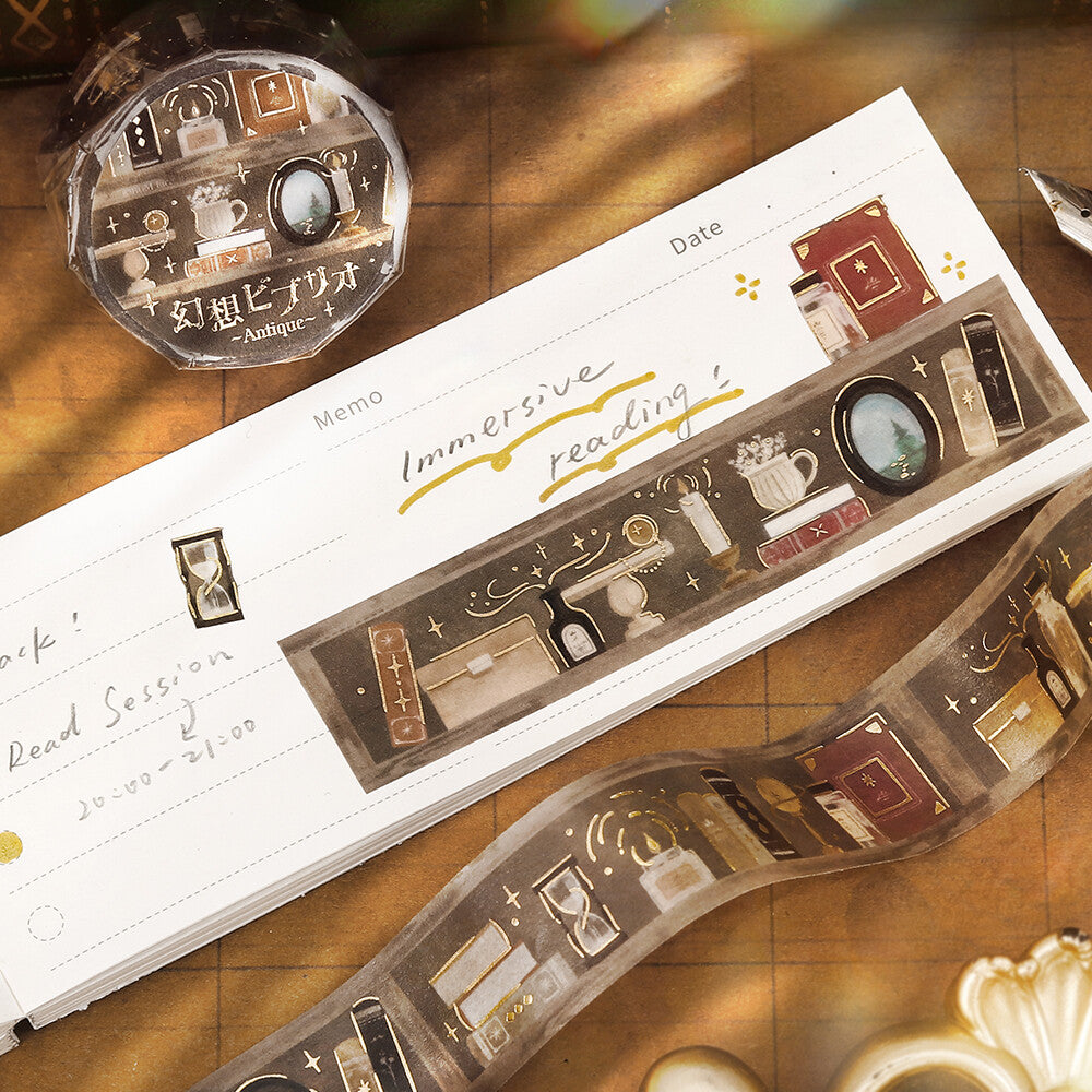 Decorative stationery with illustrated bookshelf washi tape on a wooden surface