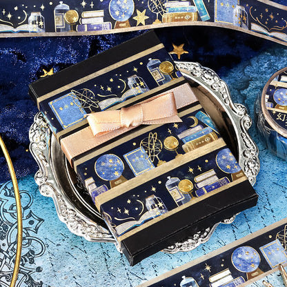 Decorative stationery with celestial design and pink bow on a blue textured surface