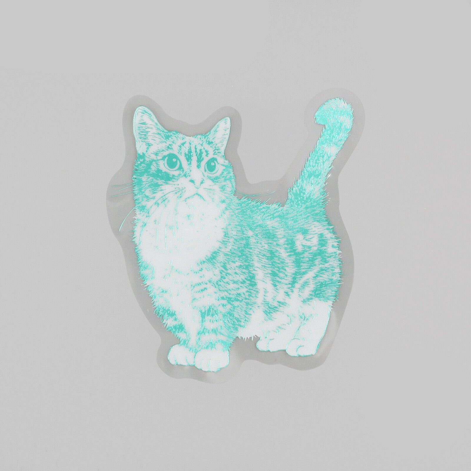 A die-cut sticker featuring a stylized cat illustration in mint green and white, shown on a light gray background