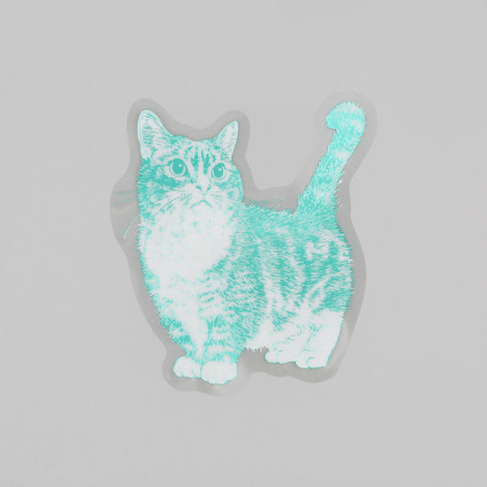 A die-cut sticker featuring a stylized cat illustration in mint green and white, shown on a light gray background