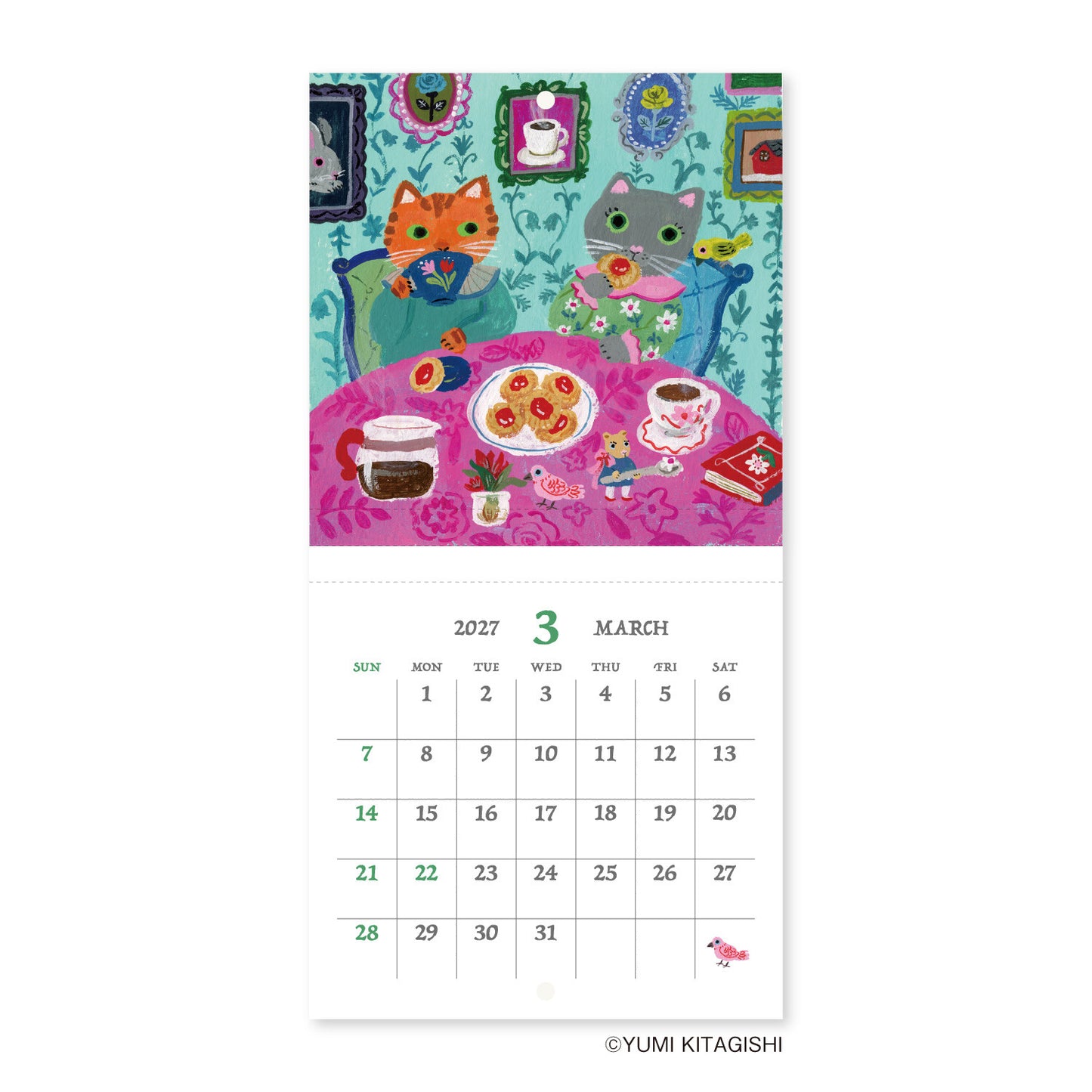 A vertical wall calendar page featuring a colorful illustration of two cats sitting at a table with tea and sweets, above a printed March 2027 calendar grid. The artist name YUMI KITAGISHI appears at the bottom.