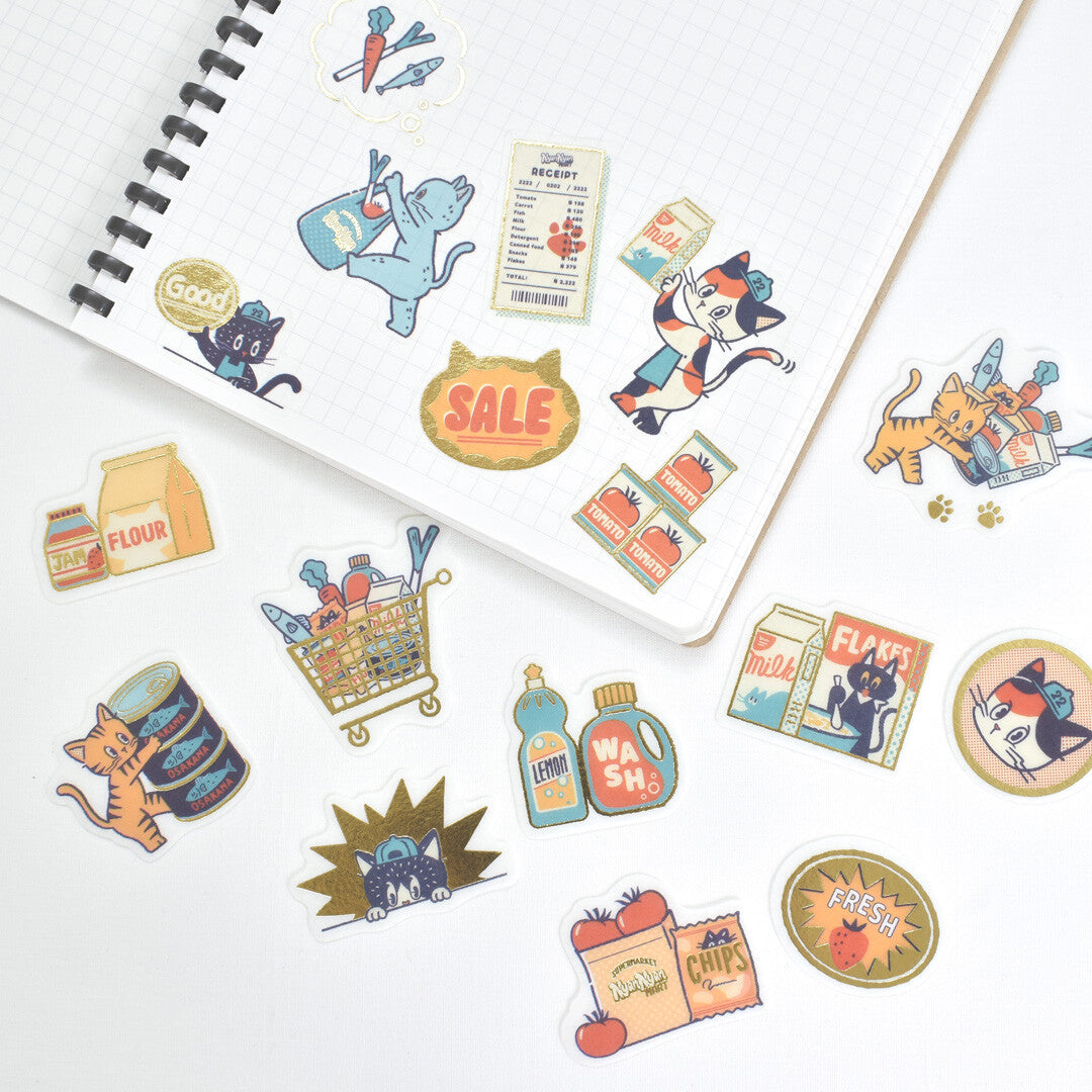 Colorful stickers with cartoon cat characters and items on a white surface