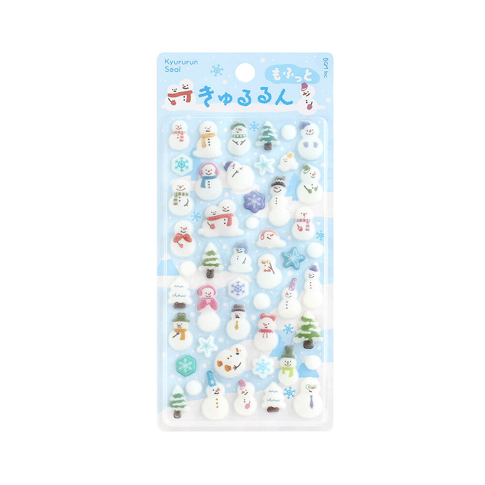 A package of small snowman-themed decorative stickers or charms on a light blue backing card, shown against a plain white background. The package contains many tiny white snowmen with colorful scarves, hats, and accessories, plus snowflake and tree motifs.