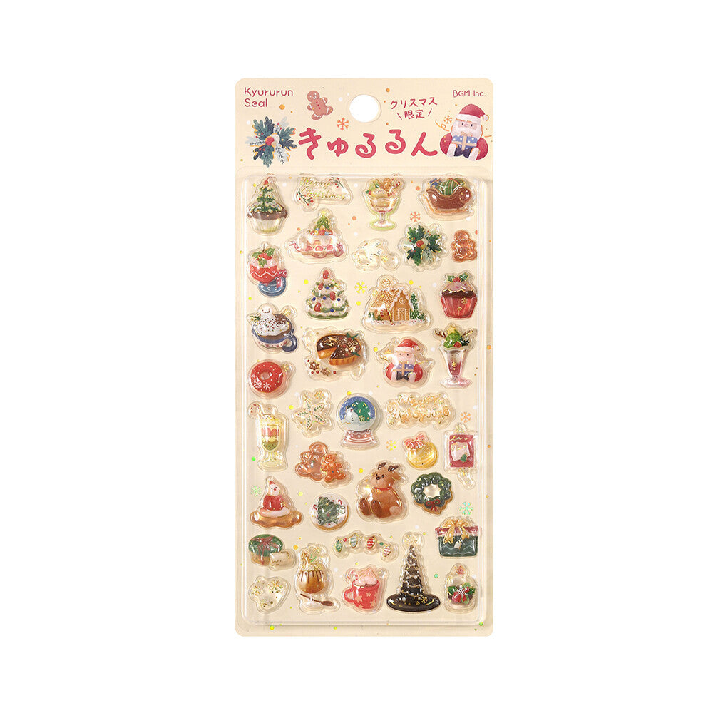 A sheet of small Christmas-themed stickers on a beige backing card, shown against a white background. 