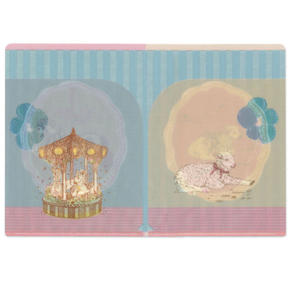The interior of a clear A5 file folder with two illustrated scenes side by side: a carousel under a blue striped sky on the left, and a sleeping lamb under a pale pink sky on the right. The pocket has a light blue center stripe and pink border lines.