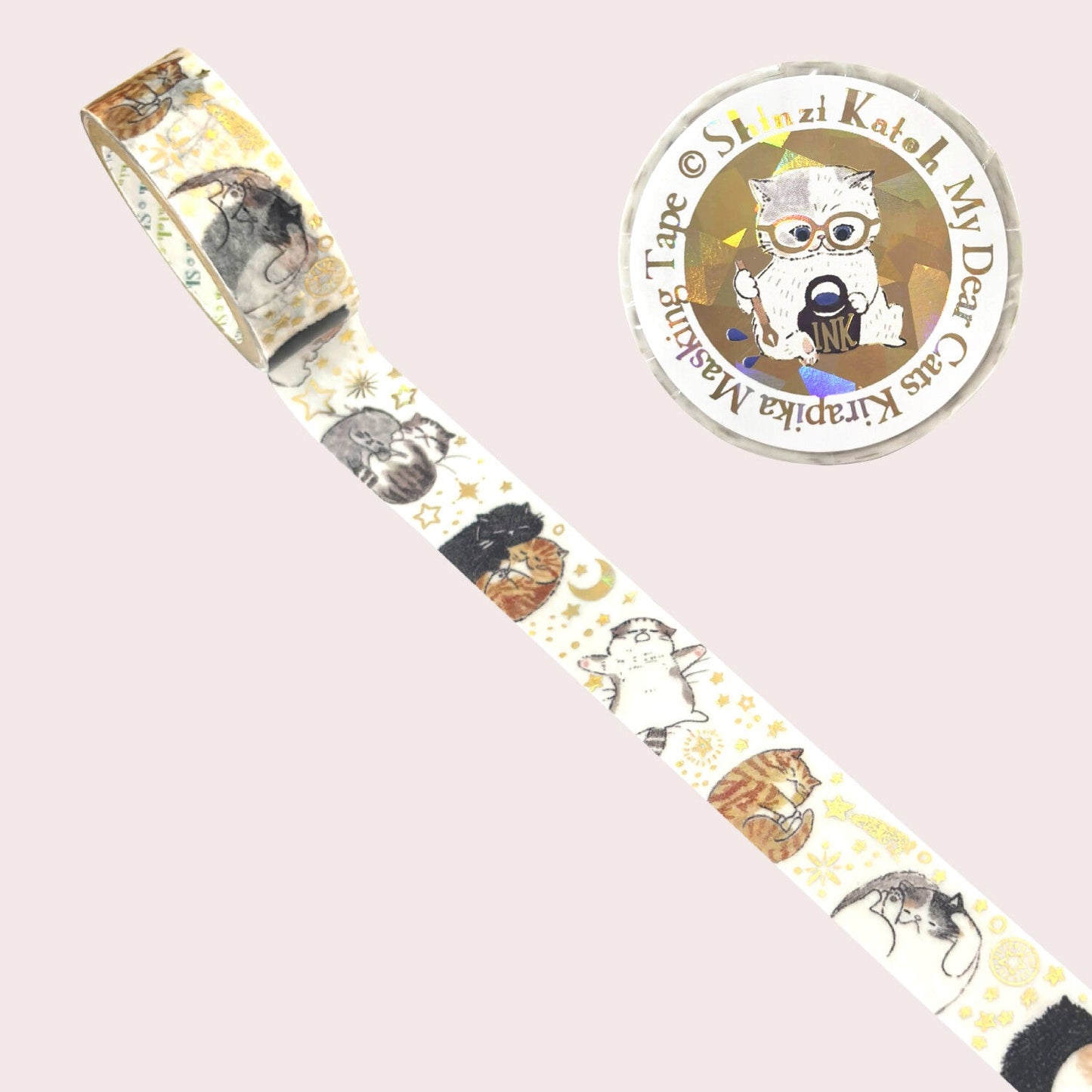 A roll of decorative masking tape with a whimsical cat illustration pattern, shown diagonally on a pale pink background.