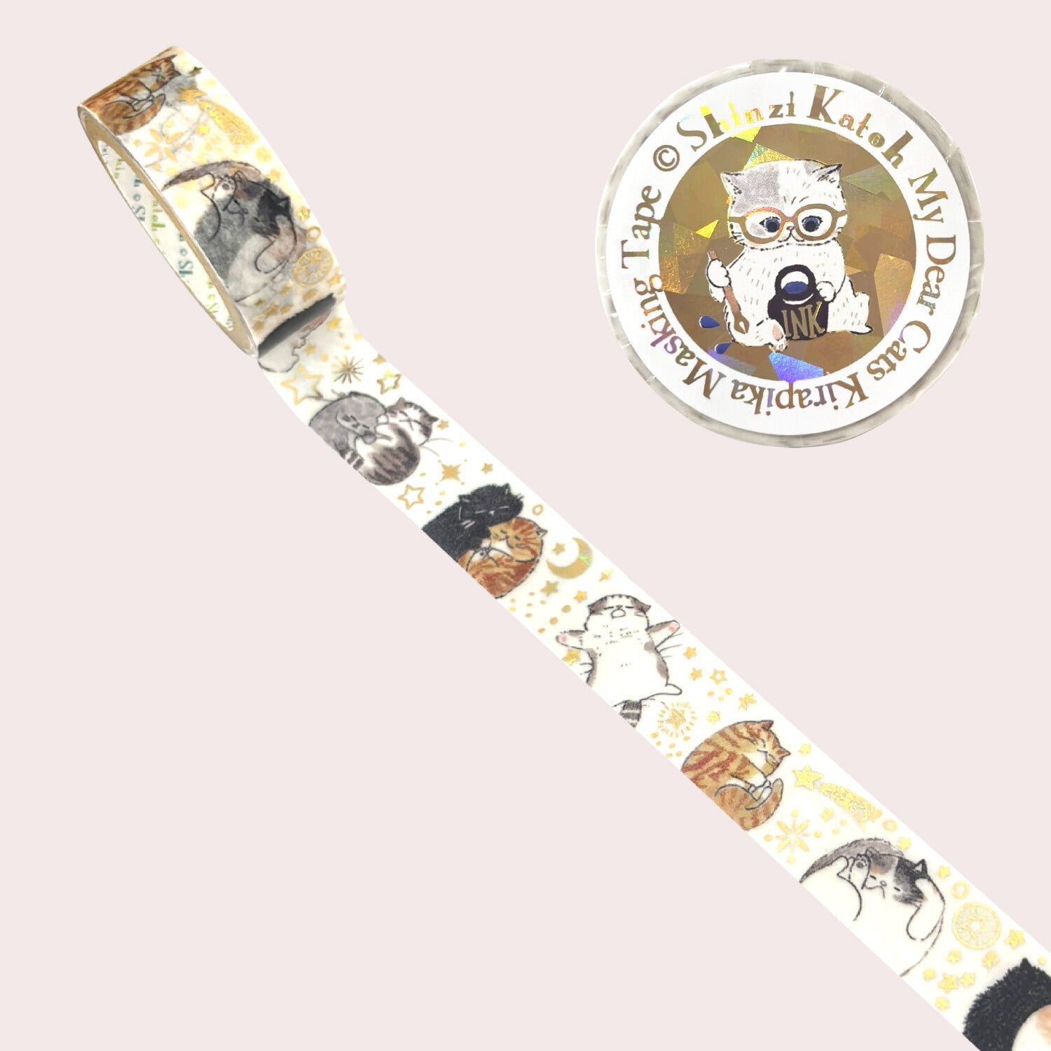 A roll of decorative masking tape with a whimsical cat illustration pattern, shown diagonally on a pale pink background.