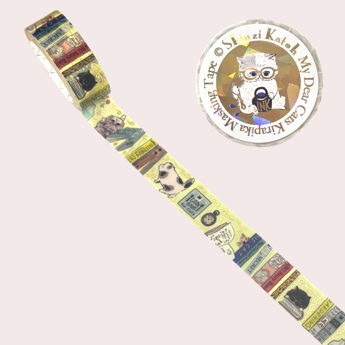A roll of decorative tape featuring vintage book and cat illustrations, shown diagonally on a pale pink background.