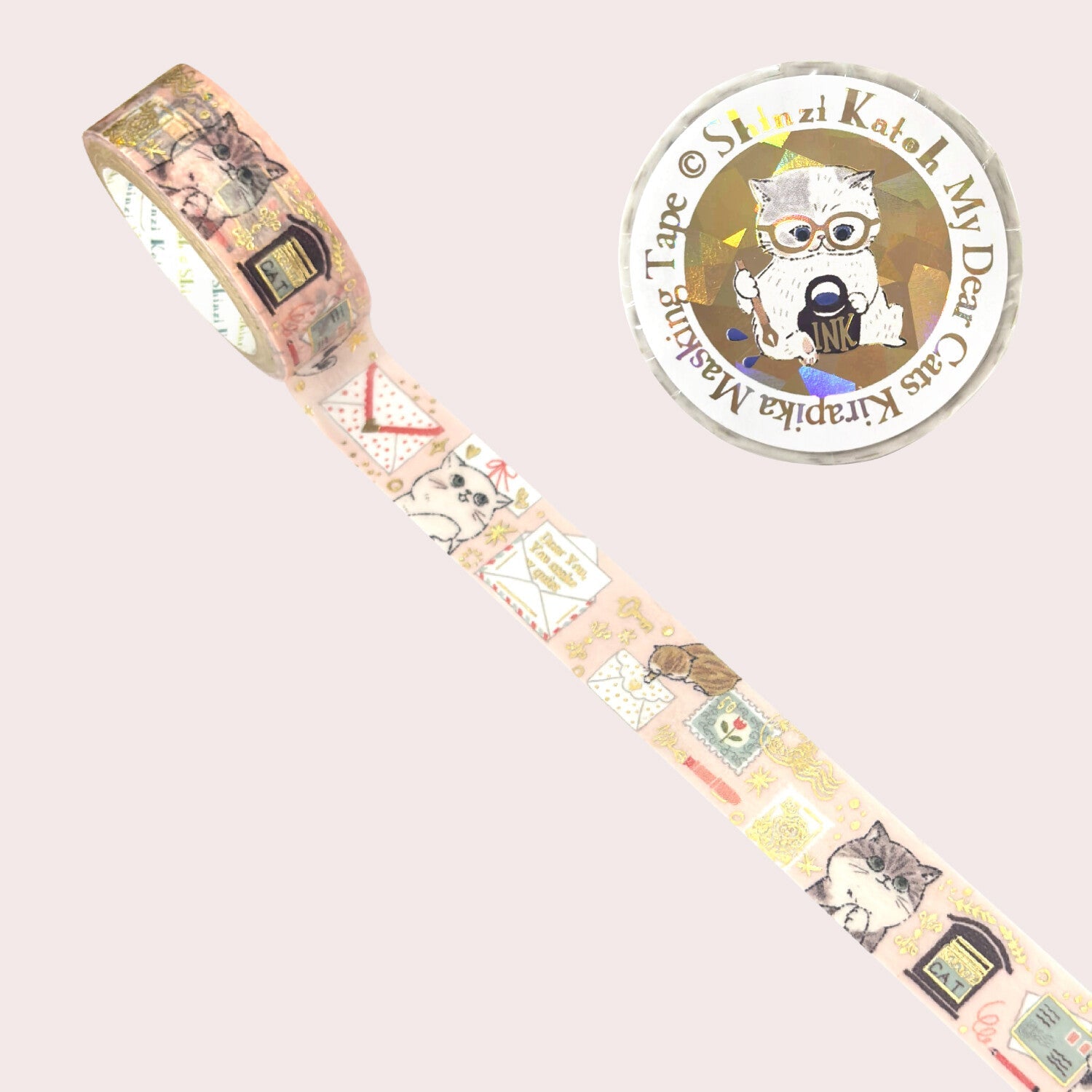 A roll of decorative washi tape with a vintage cat-themed postmark pattern, shown diagonally on a pale pink background.