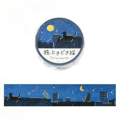 A roll of decorative tape wrapped in clear plastic with a circular label reading 'The Cat's Journey,' shown above an unwrapped strip of the same design. The tape features a dark blue night sky with stars, a yellow moon, and black cat silhouettes sitting on rooftops above city buildings.