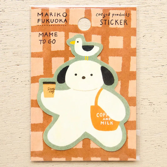 A packaged sticker featuring a cute cartoon dog holding a coffee cup and wearing a shoulder bag labeled 'COFFEE AND MILK,' with a small bird on its head. The sticker is mounted on a peach-and-white checkered backing card with the text 'MARIKO FUKUOKA' and 'MAME TO GO.
