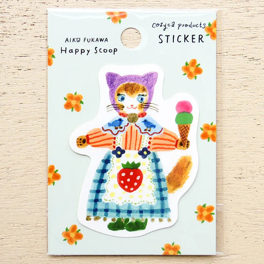 A die-cut sticker featuring a whimsical cat character holding an ice cream cone, mounted on a light blue backing card with orange flower illustrations and text reading 'AIKO FUKAWA Happy Scoop' and 'Cozya products STICKER'.