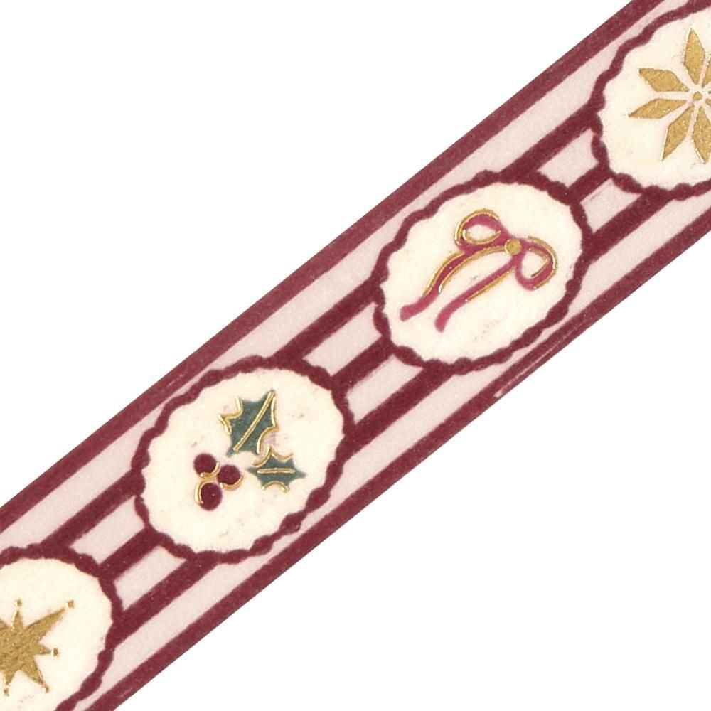 A close-up of a decorative washi tape featuring a burgundy and cream striped pattern with holiday motifs including holly leaves, a bow, and stars.