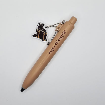 Beige pen with a bear keychain on a white background