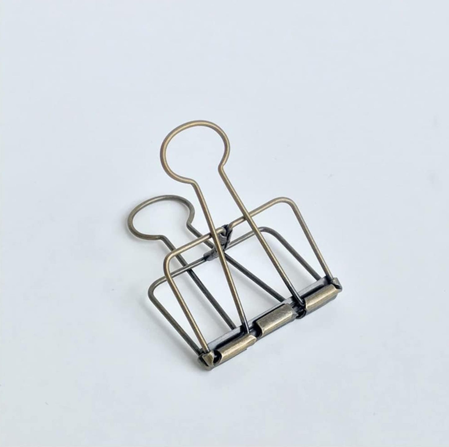 Metallic paper clip on a light background