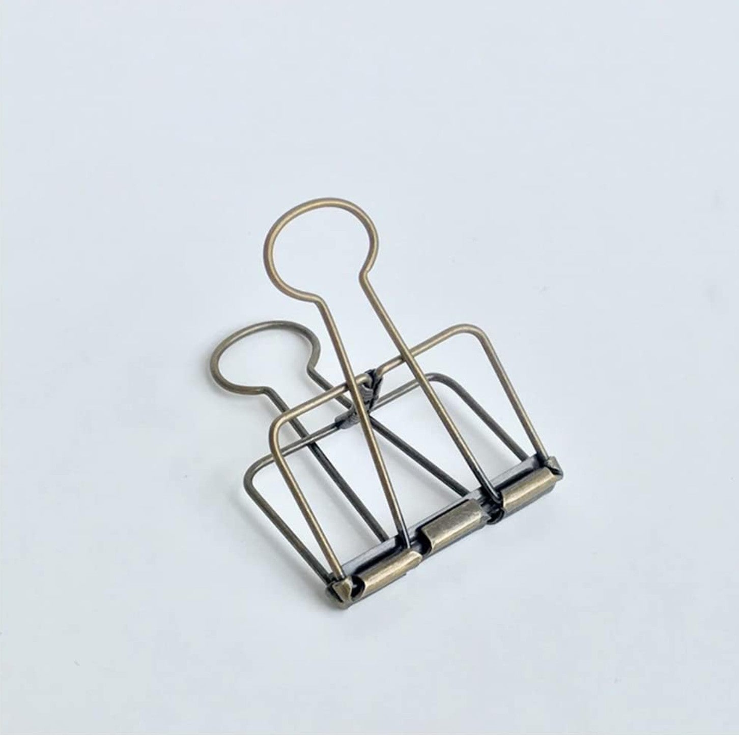 Metallic paper clip on a light background