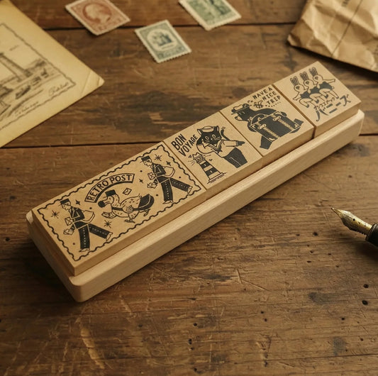 Set of vintage-style rubber stamps on a wooden surface with stamps and paper in the background.