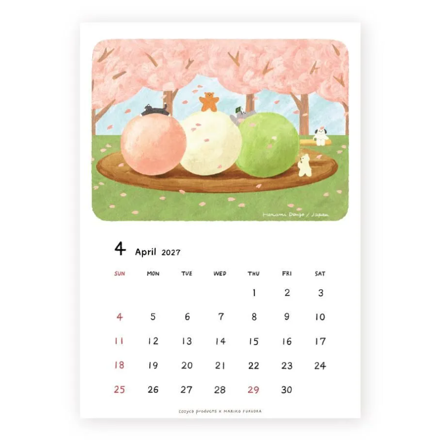 A single-page illustrated calendar print showing April 2027 with a pastel cherry-blossom scene above the dates. The artwork features pink blossoms, green grass, and three large round dango mochi treats on a wooden platform, with small animal figures.
