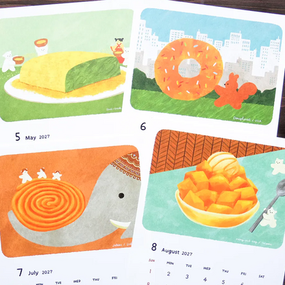 A close-up of a printed illustrated calendar page showing monthly panels for May, June, July, and August 2027. The artwork uses a playful, colorful style with food-themed illustrations: a large cake on May, a donut on June, a whale-shaped spiral dessert on July, and a bowl of fruit on August.