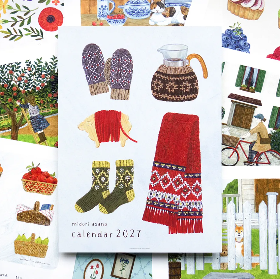 A 2027 calendar titled 'midori asano calendar 2027' displayed flat, surrounded by a collage of colorful folk-art style illustrations including mittens, a patterned coffee pot, a red sweater, socks, apples, a bicycle, and a white picket fence.