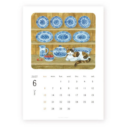 A single-page calendar showing June 2027 on a white page, with a central illustrated panel of blue-and-white ceramic dishes and a calico cat on a wooden shelf.