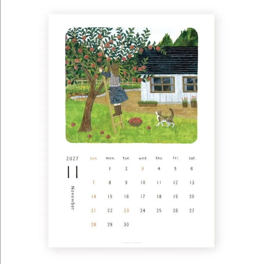A single-page 2027 calendar print showing November with an illustrated apple orchard scene above the calendar grid. The artwork depicts a person climbing a ladder toward an apple tree next to a white cottage, with a cat in the foreground.