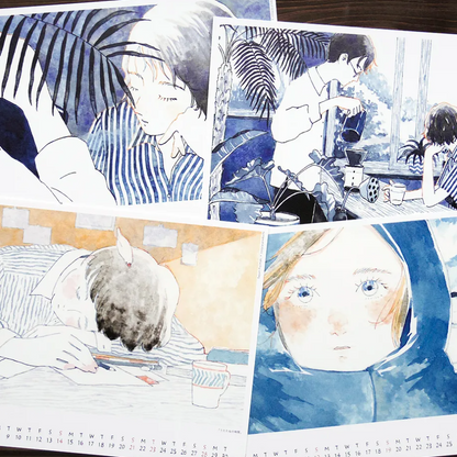 A collage of four illustrated anime-style calendar pages with blue, white, and warm beige tones, showing characters in a cafe and close-up portraits. The panels are arranged on a dark wood surface, with printed text and a calendar visible along the bottom edge.