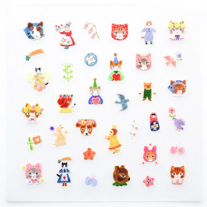 A sheet of small nail stickers on a white background, including cats, dogs, birds, flowers, dolls, and whimsical figures in many pastel and bright colors.