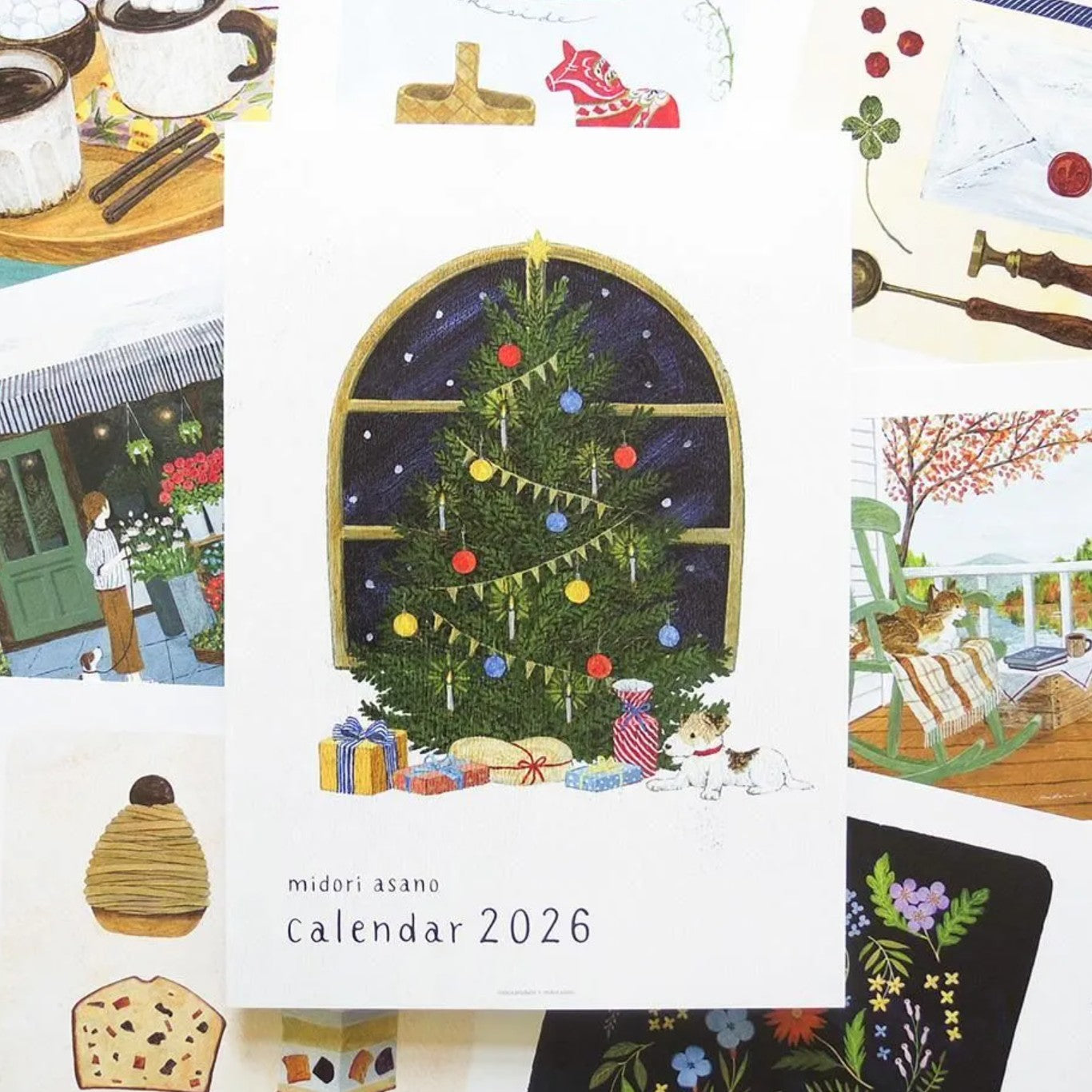 Collage of illustrations for a 2026 calendar by Midori Asano, featuring a Christmas tree and various scenes.
