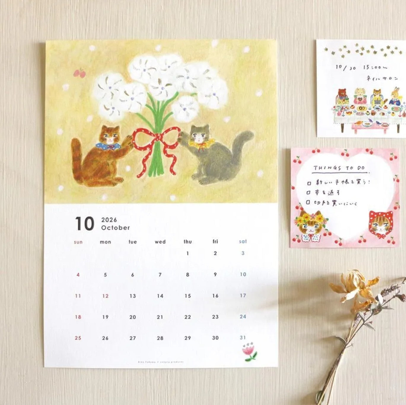 Calendar with cats and flowers on a wooden surface